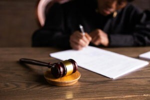 Car accident lawyer in Palmdale, CA doing compensation paperwork for injured client