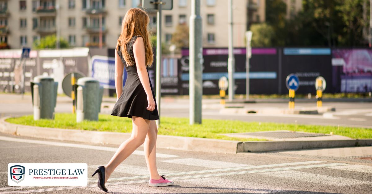 Pedestrian crossing a city street mid-block away from a crosswalk