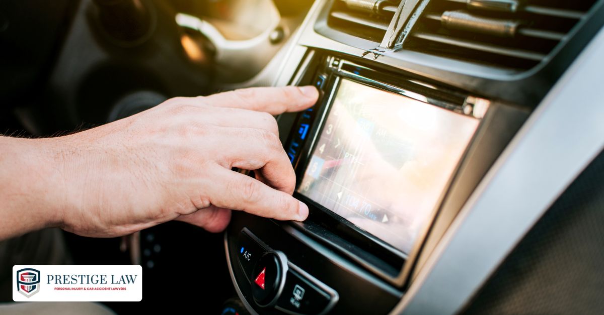 Driver removing hand from wheel to adjust radio while driving.