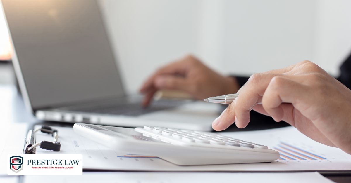 Contingency fee agreement with calculator and settlement check on desk.