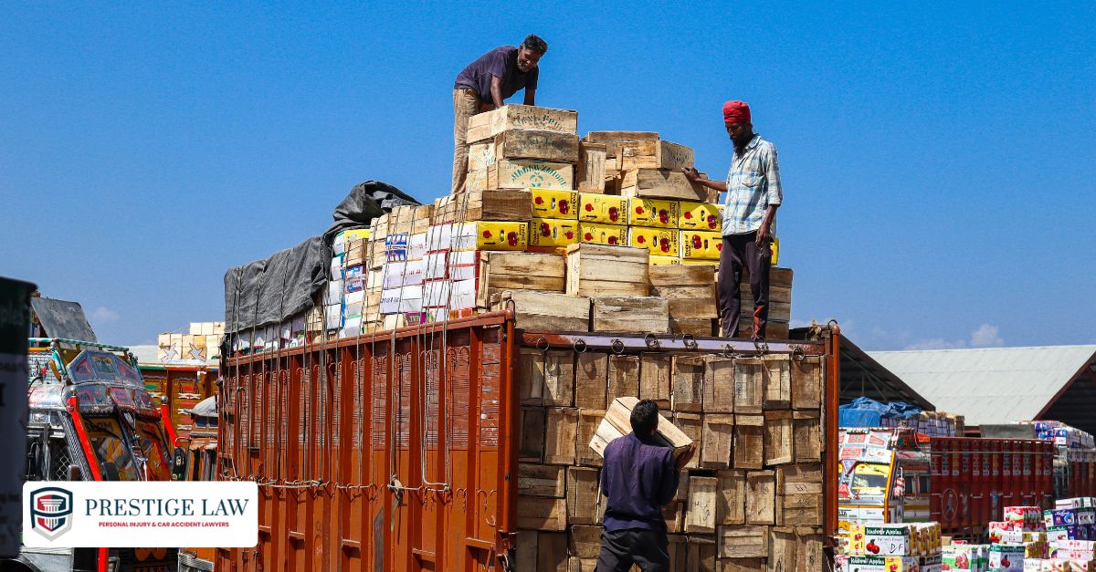 How Truck Weight Impacts Safety and Liability? Warehouse workers loading a semi-truck and checking cargo weight