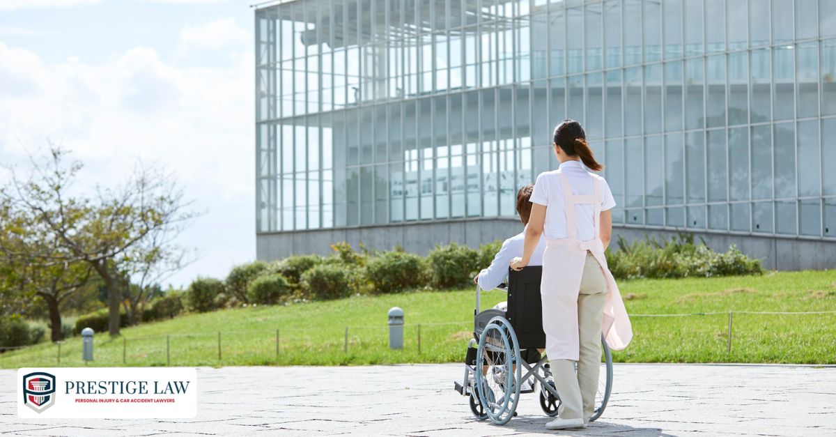Person with visible scarring and mobility brace sits in a rehab center, assisted by a caregiver