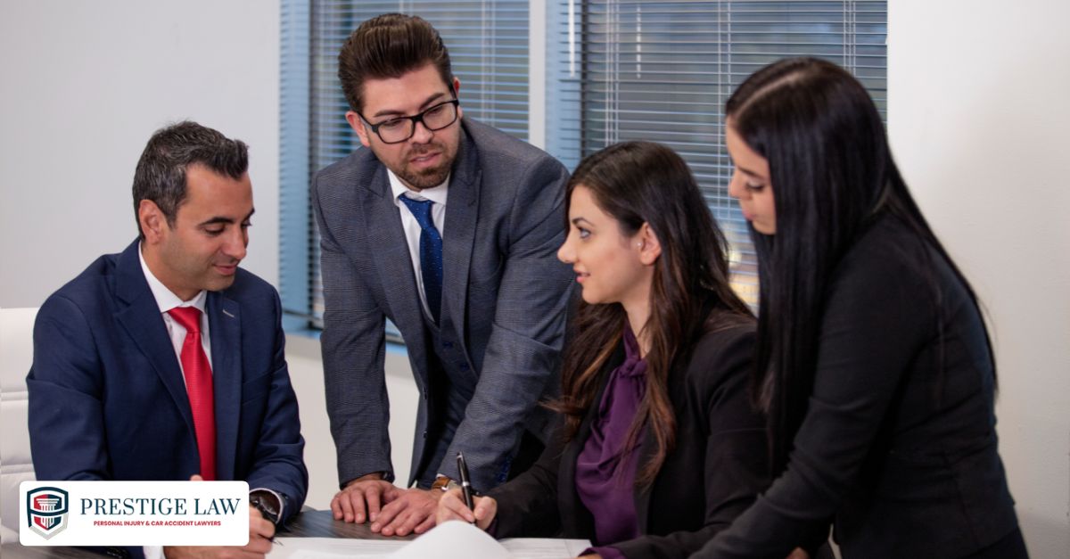 Prestige Law Firm P.C. legal team meeting to review car accident case evidence
